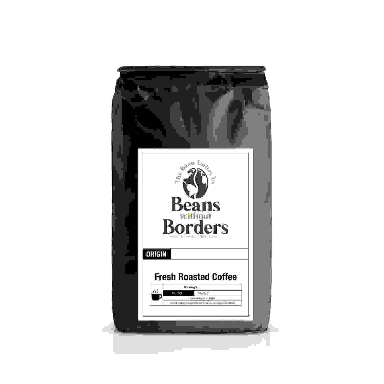 Papua New Guinea single origin fresh roasted coffee in black Beans Without Borders bag, featuring origin and roast details on front label.